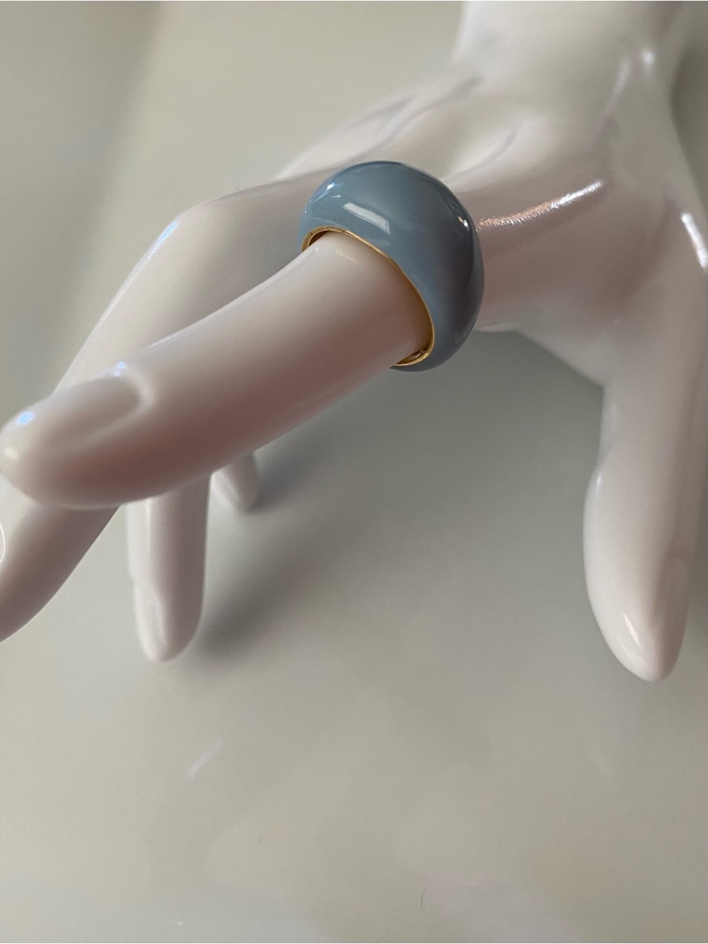 A Frasier Sterling baby blue enamel dome ring with a gold-tone band.
